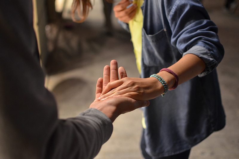 Someong giving a helping hand to guide someone else.