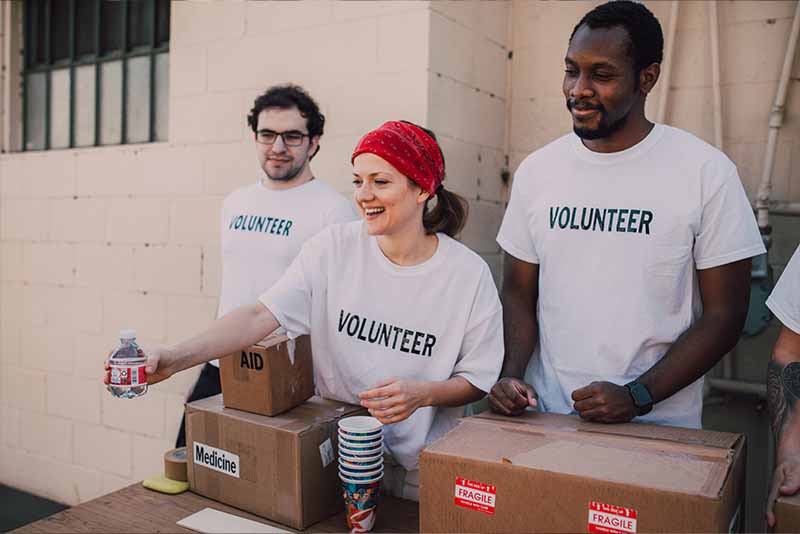 Volunteers giving our food and water.